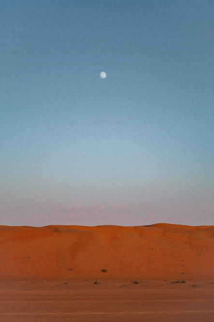 Moon Above the Mountain of Sand in a Desert